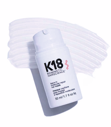 K18 hair mask bottle with white hair strands on a white background