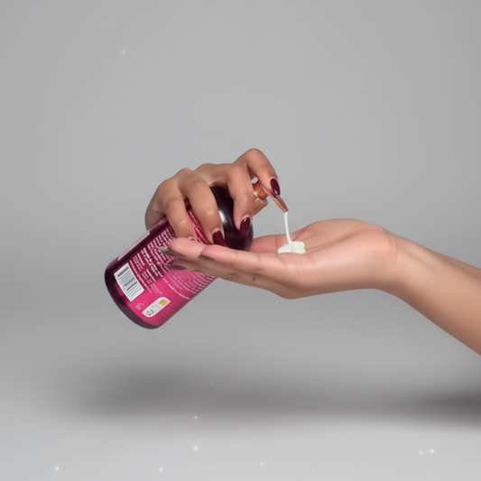 Woman applying a pink lip balm to her lips with a visible brand label.