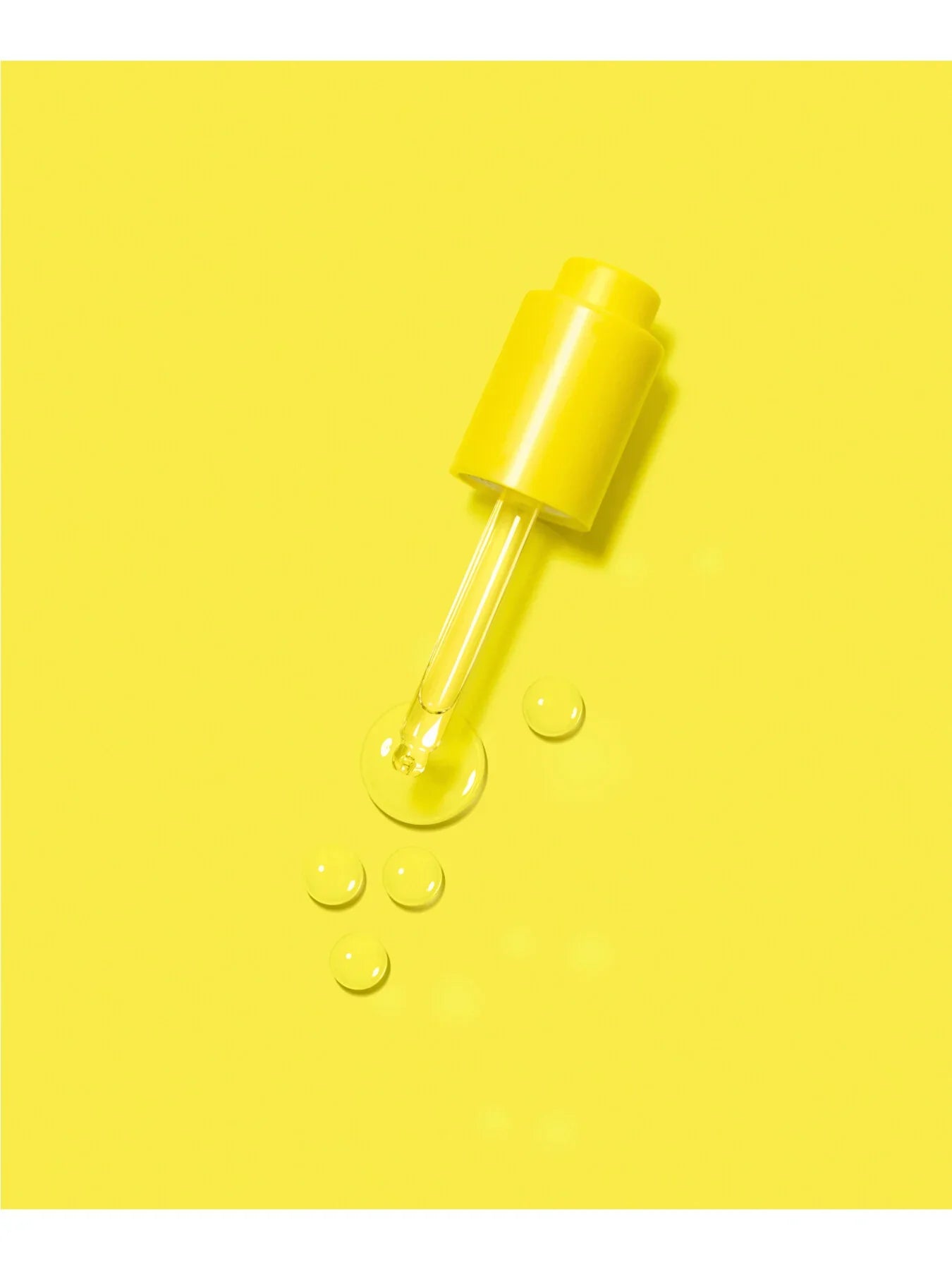 Droplets of oils on a yellow paper for a tube