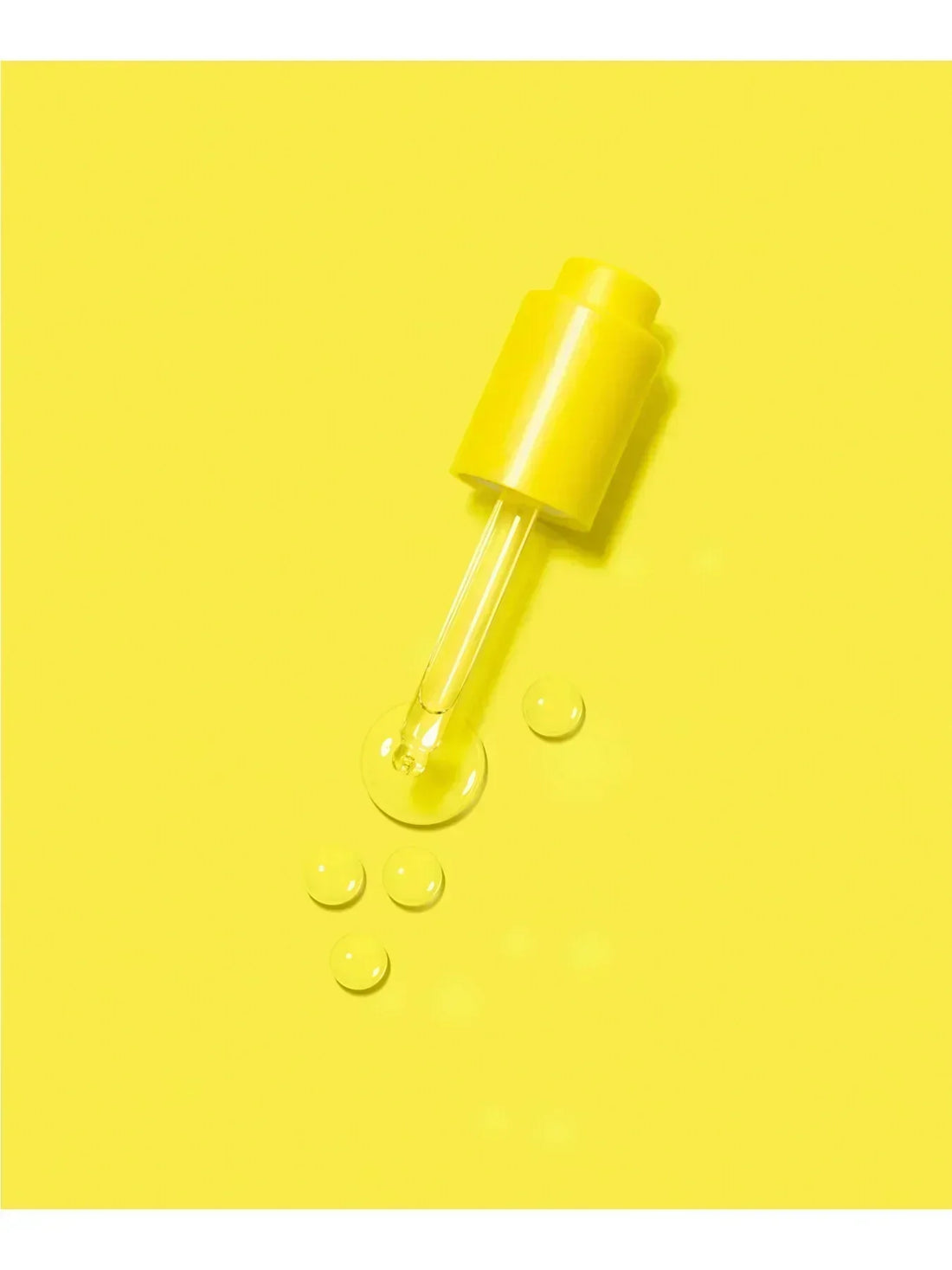 Droplets of oils on a yellow paper for a tube