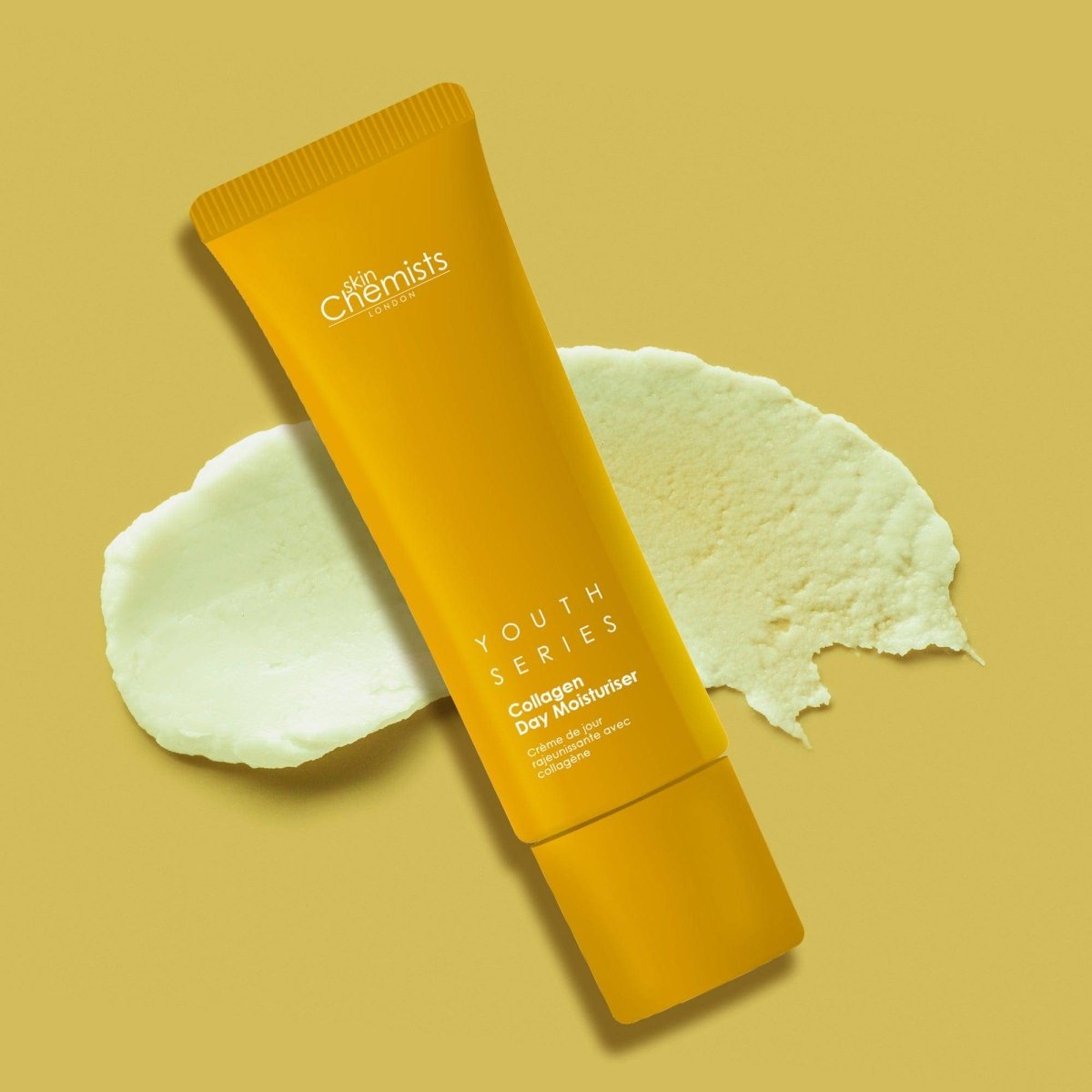 Yellow skincare tube labeled 'The Chemists' on a beige background