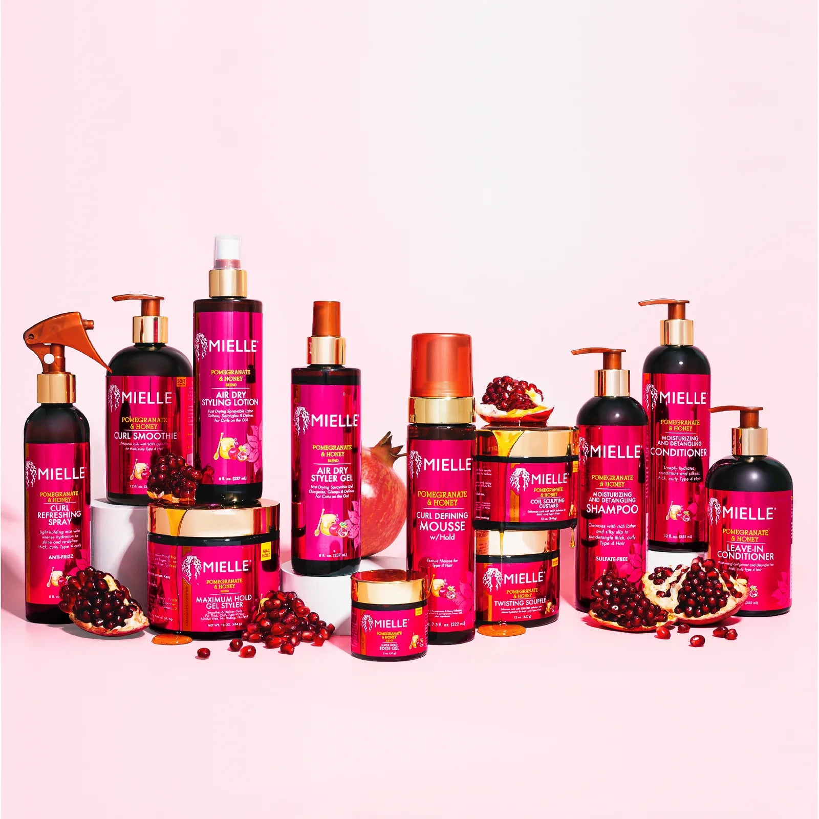 Range of hair products in a pink bottles arranged on stands on a baby pink background.