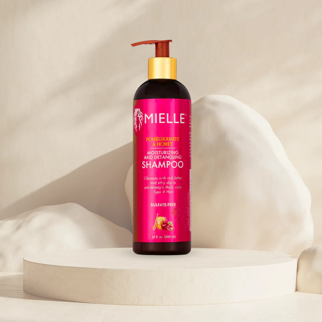 Mielle Organics shampoo bottle on a beige background