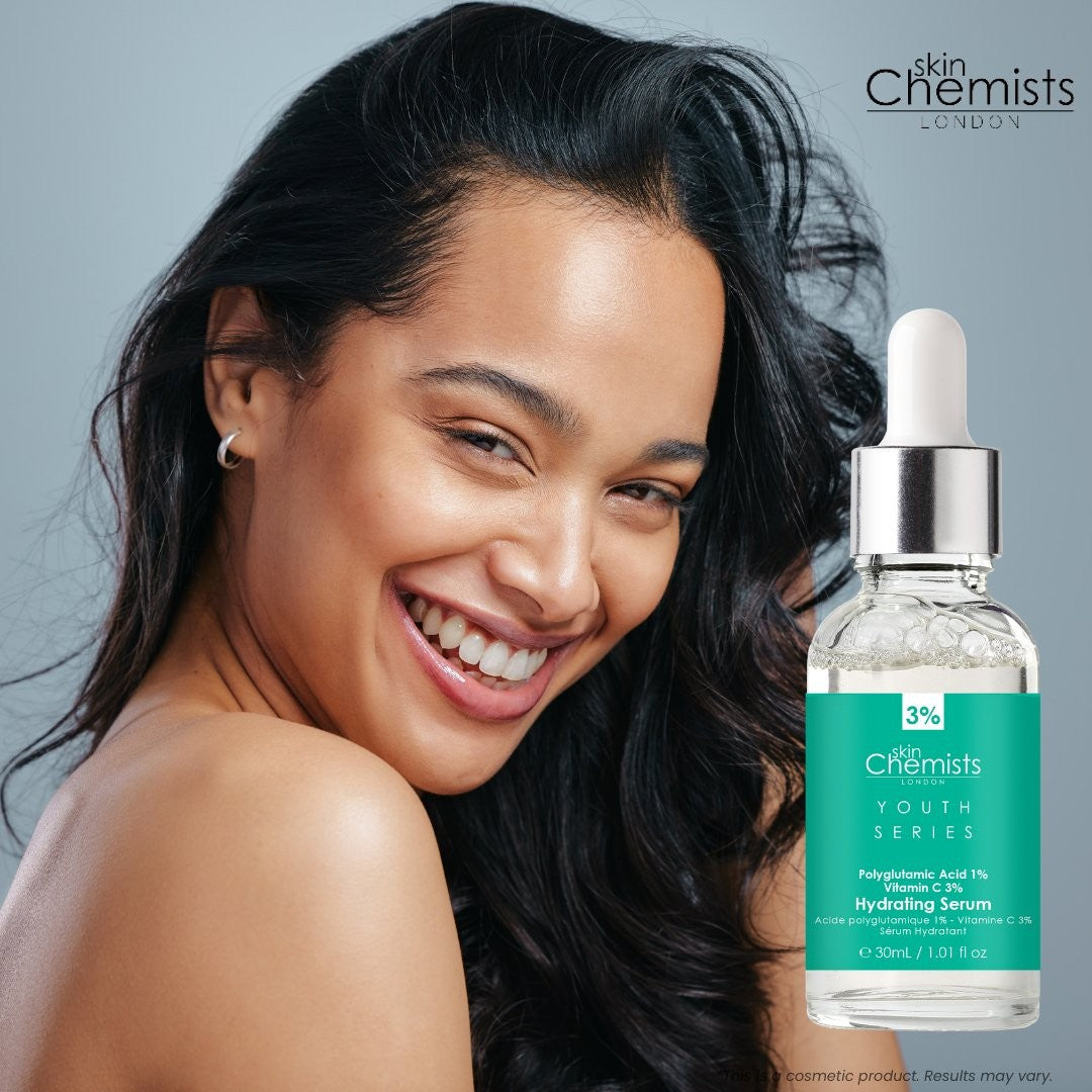 Woman with a skincare product bottle labeled 'skin Chemists' on a gray background