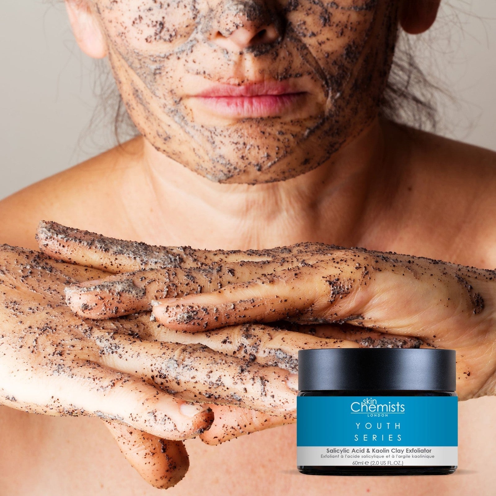 Person applying a face mask with a jar of 'Chemists Youth Series' product in the foreground.