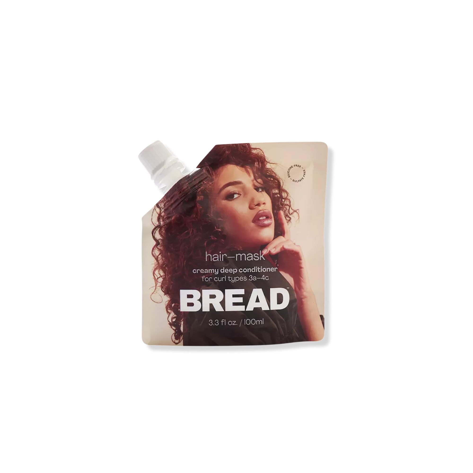 Hair mask packaging with a woman's face on the label, featuring the brand 'Bread'.