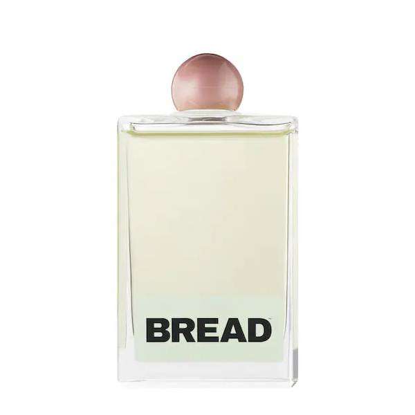 A bottle of oil in a glass bottle against a white background