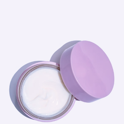 A picture of a hair cream opened to display a creamy white texture 