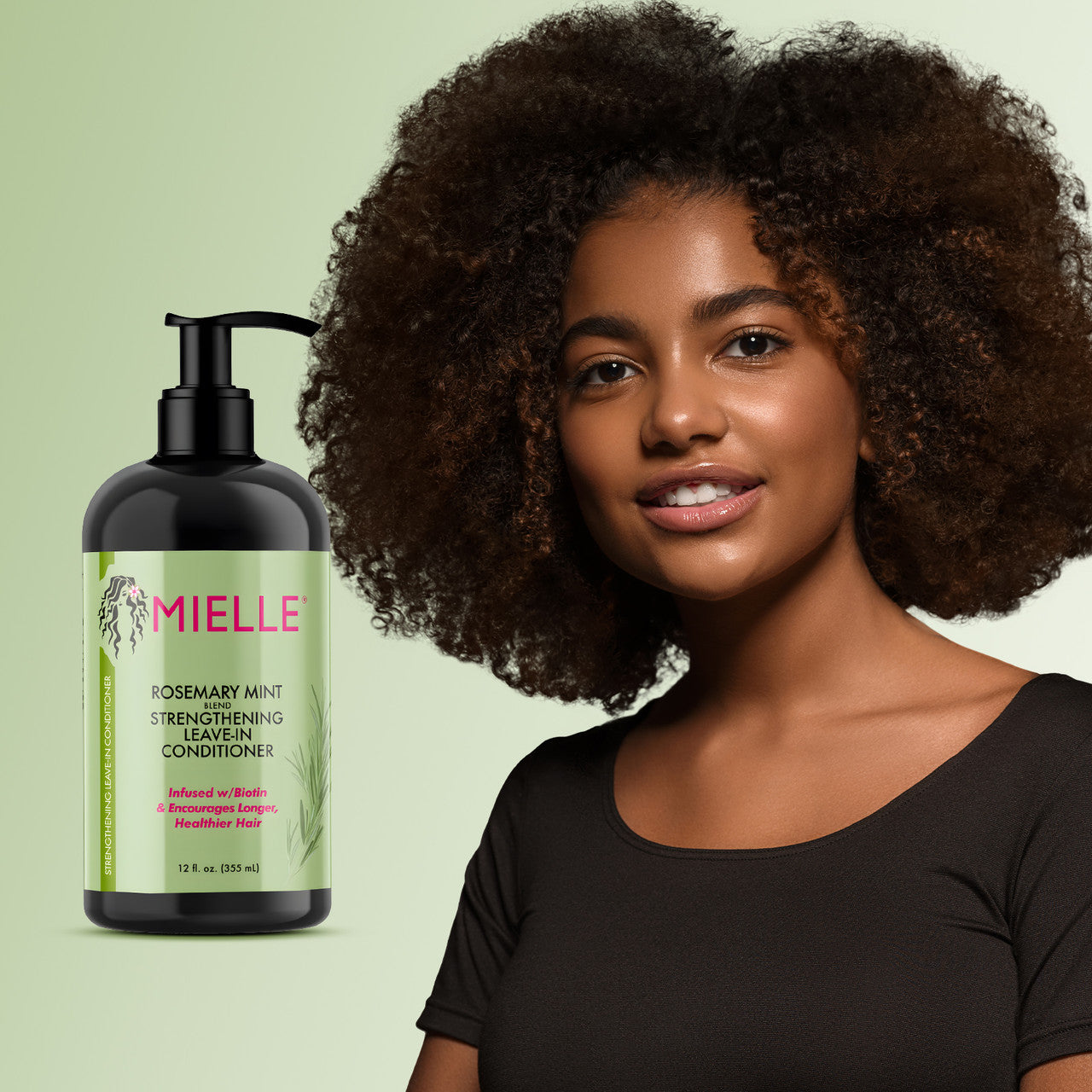 Woman with curly hair next to a bottle of Mielle Rosemary Mint Strengthening Leave-In Conditioner on a green background
