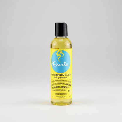 Yellow bottle of Curls Blueberry Bliss hair growth oil on a white background