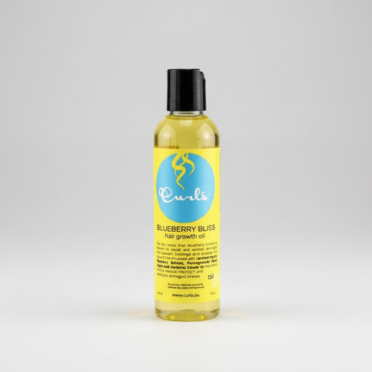 Yellow bottle of Curls Blueberry Bliss hair growth oil on a white background