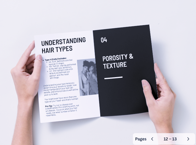 Person holding a book open to a page about hair types and porosity on a white background