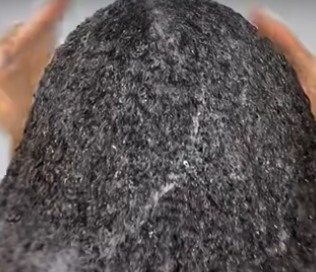 Close-up of a dark gray stone held between fingers