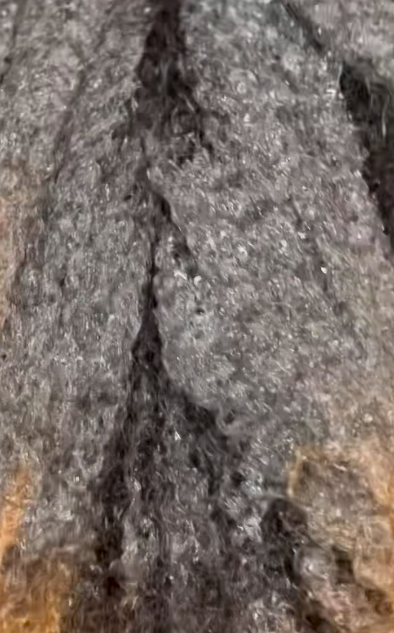 Close-up of a textured surface with a crack running through it