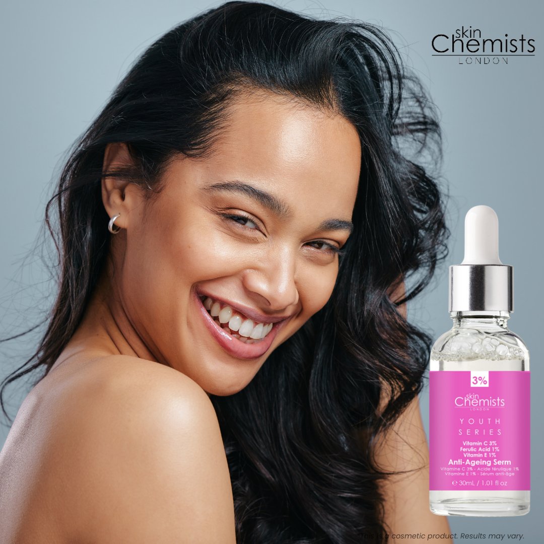 Woman with a smile next to a bottle of skinChemists serum on a gray background