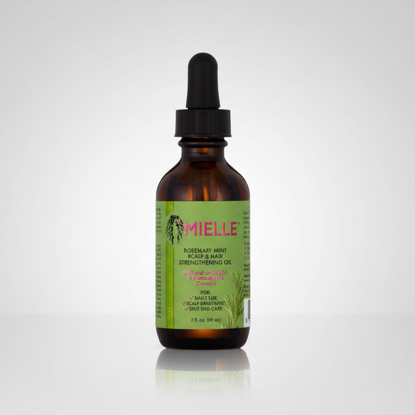 Bottle of Mielle oil with a dropper on a white background