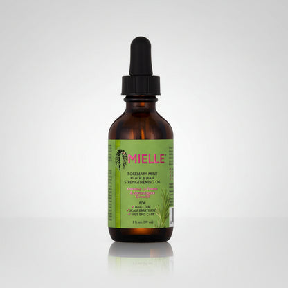 Bottle of Mielle oil with a dropper on a white background