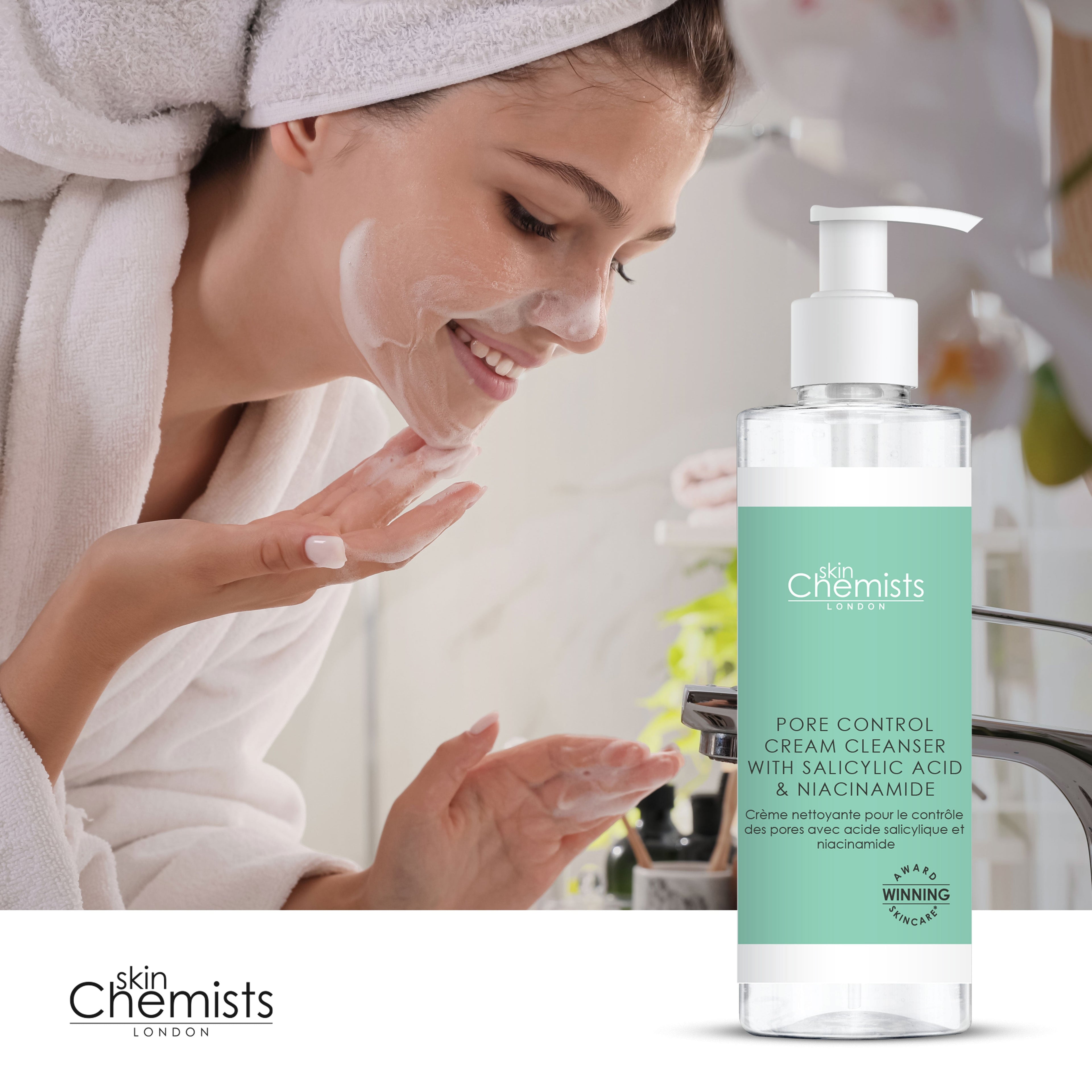 Woman applying cream to face with 'skin Chemists' cleanser bottle in foreground
