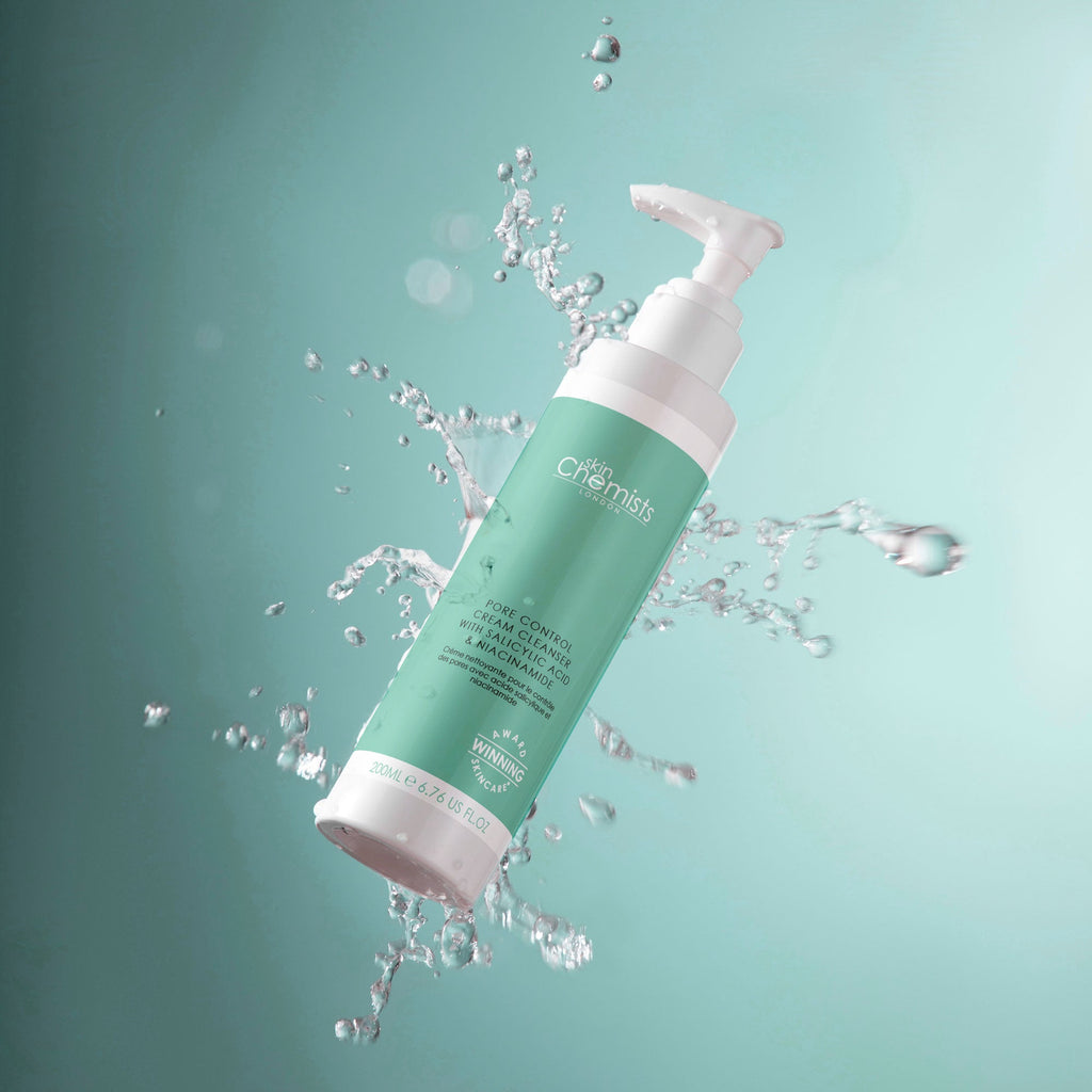 Green and white bottle with water droplets on a teal background